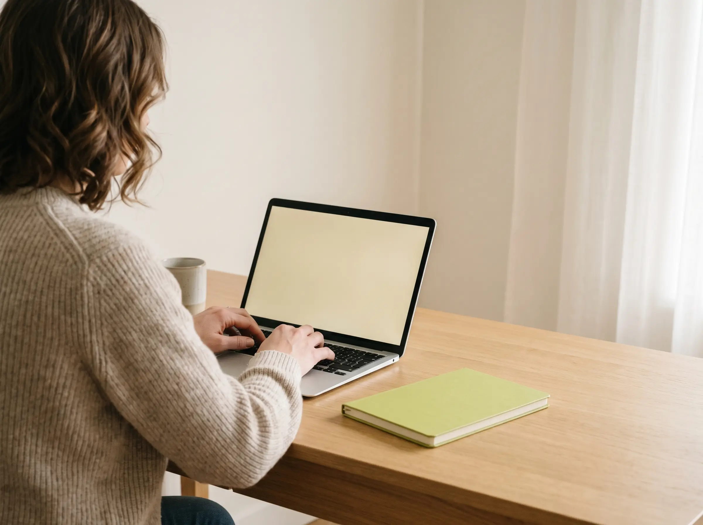 A marketing lead typing at her laptop